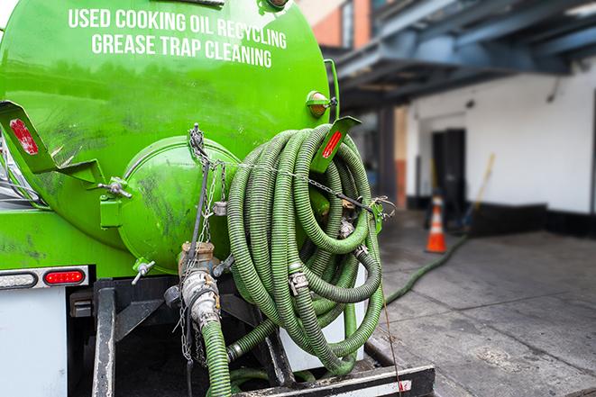 a technician pumping a grease trap in a commercial building in Deerfield IL